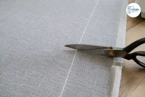 Cutting curtain fabric along a marked line
